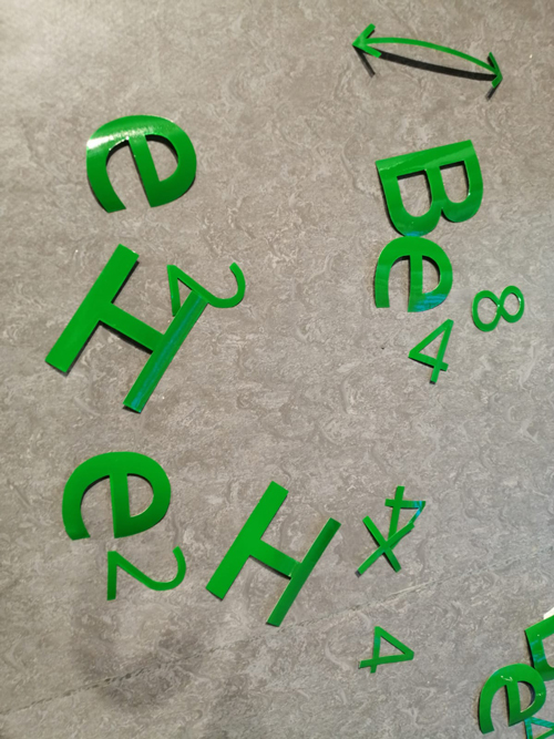 Hellium burning green letters in vinyl on floor